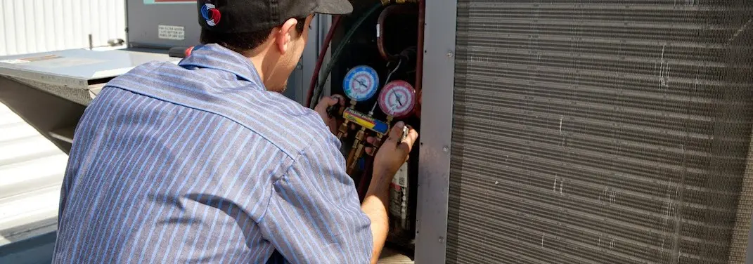 HVAC technician servicing a condenser unit in Lady Lake